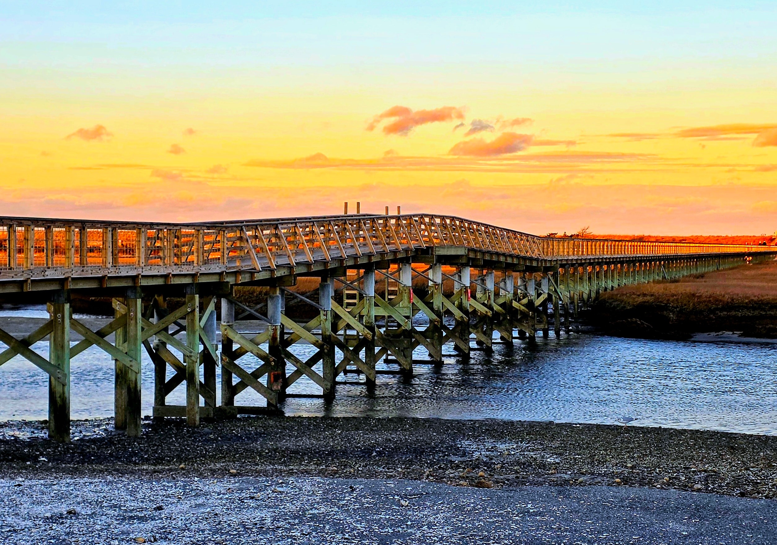 Golden highway sunset with dramatic orange sky